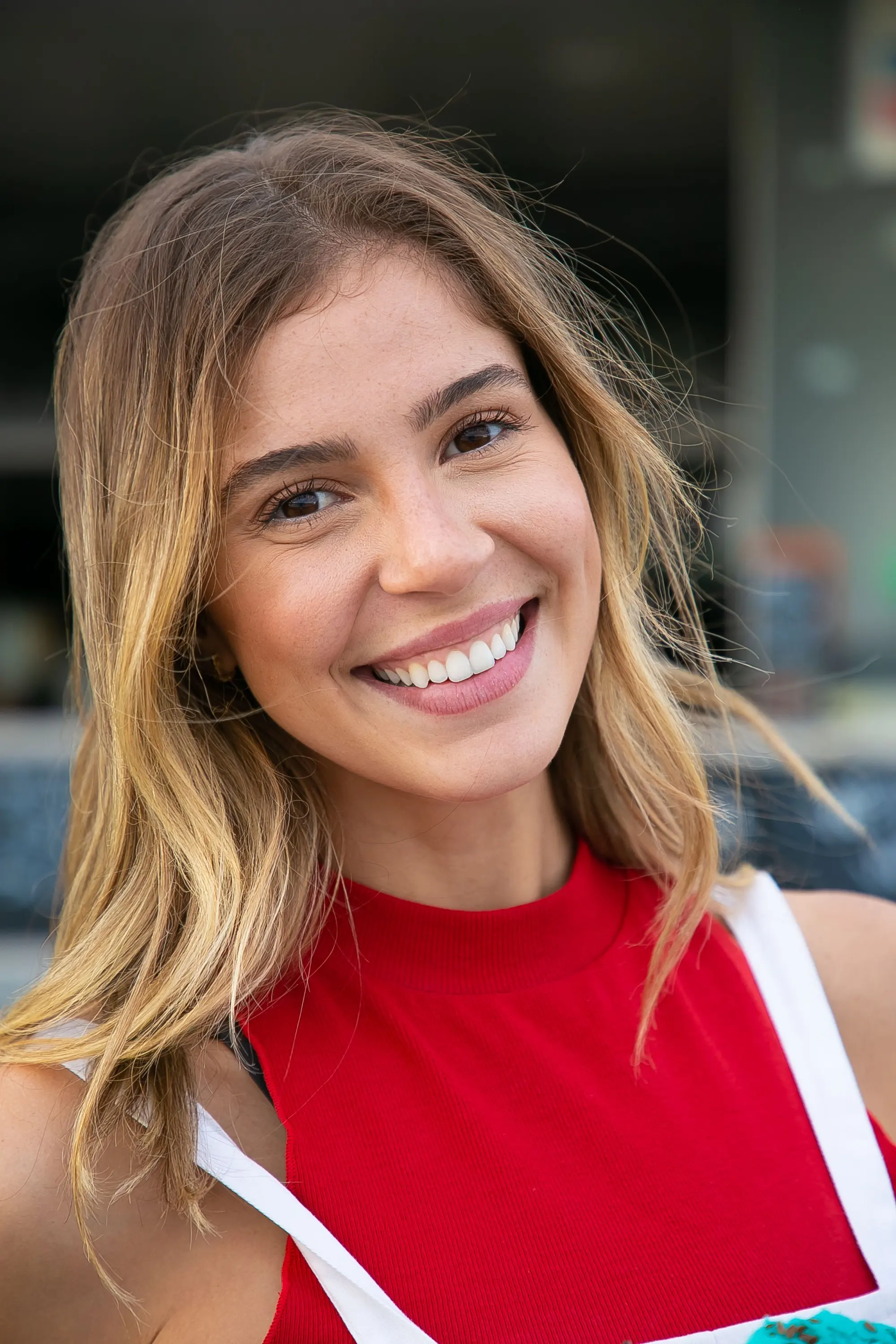 A smiling woman with long hair looking at the camera